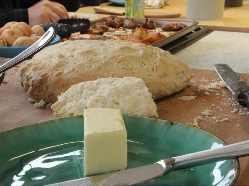 a piece of bannock bread with a side of butter