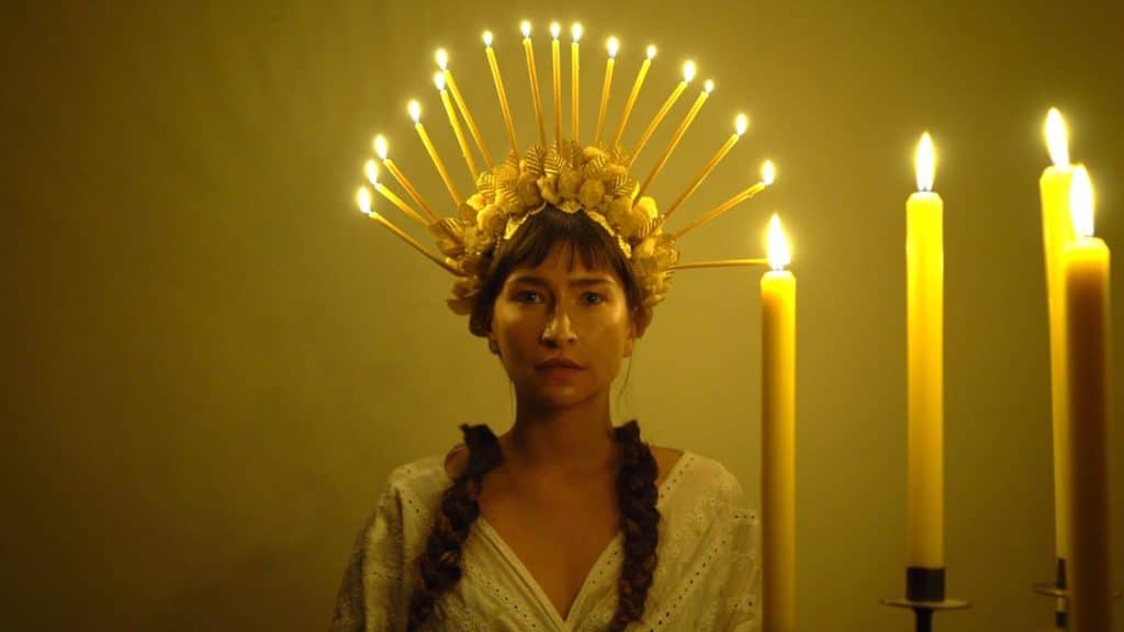 woman with candles on head