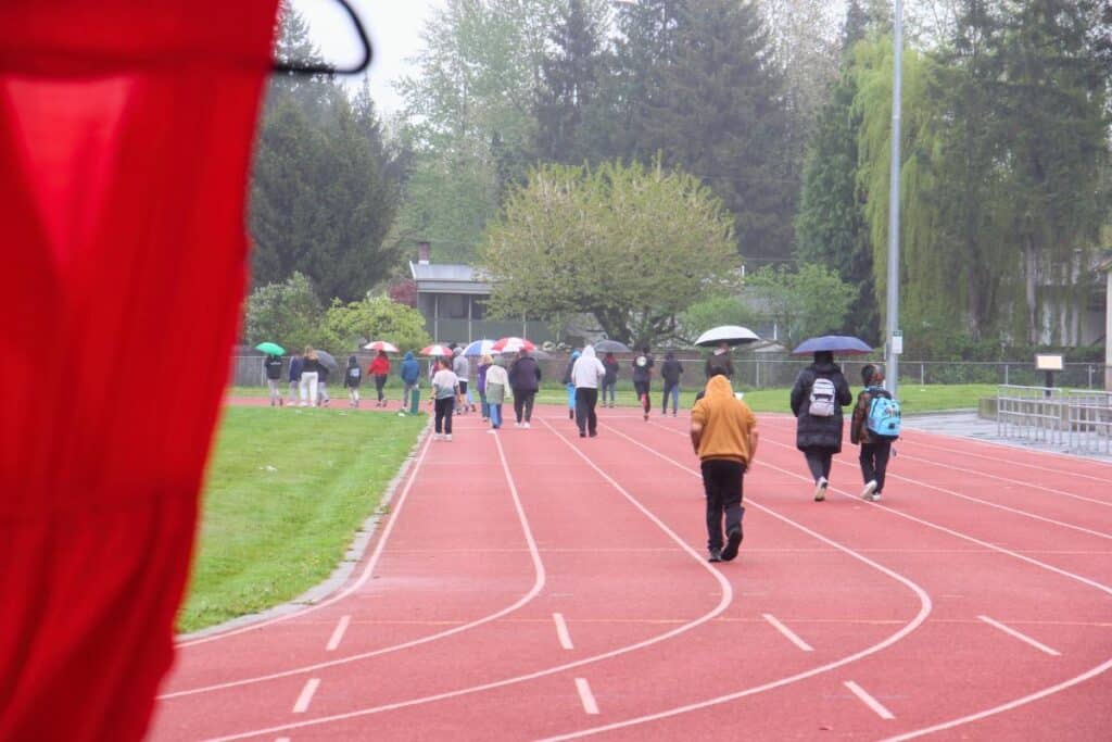 People walking on track inside school
